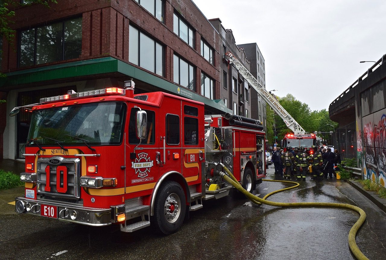 Firefighters rescue two people from their burning apartment in the Downtown Seattle