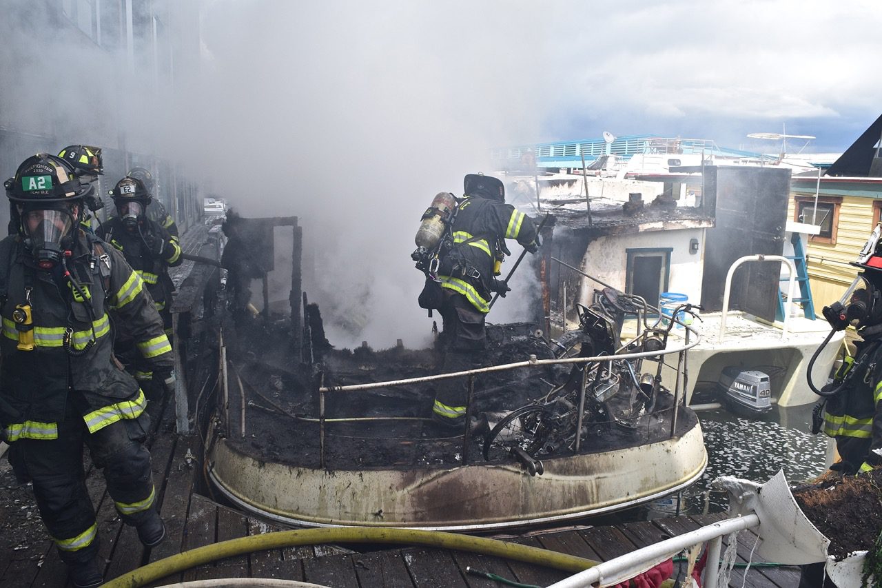 Seattle firefighters extinguished a fire involving two houseboats and a four-story commercial building in the 1800 block of Westlake Avenue North.