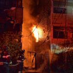 Two Seattle firefighters work to put water on a fire in a condominium building in the 8800 block of Nesbit Ave. N. in the North Greenlake neighborhood.