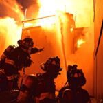 Firefighters putting water on a fire.