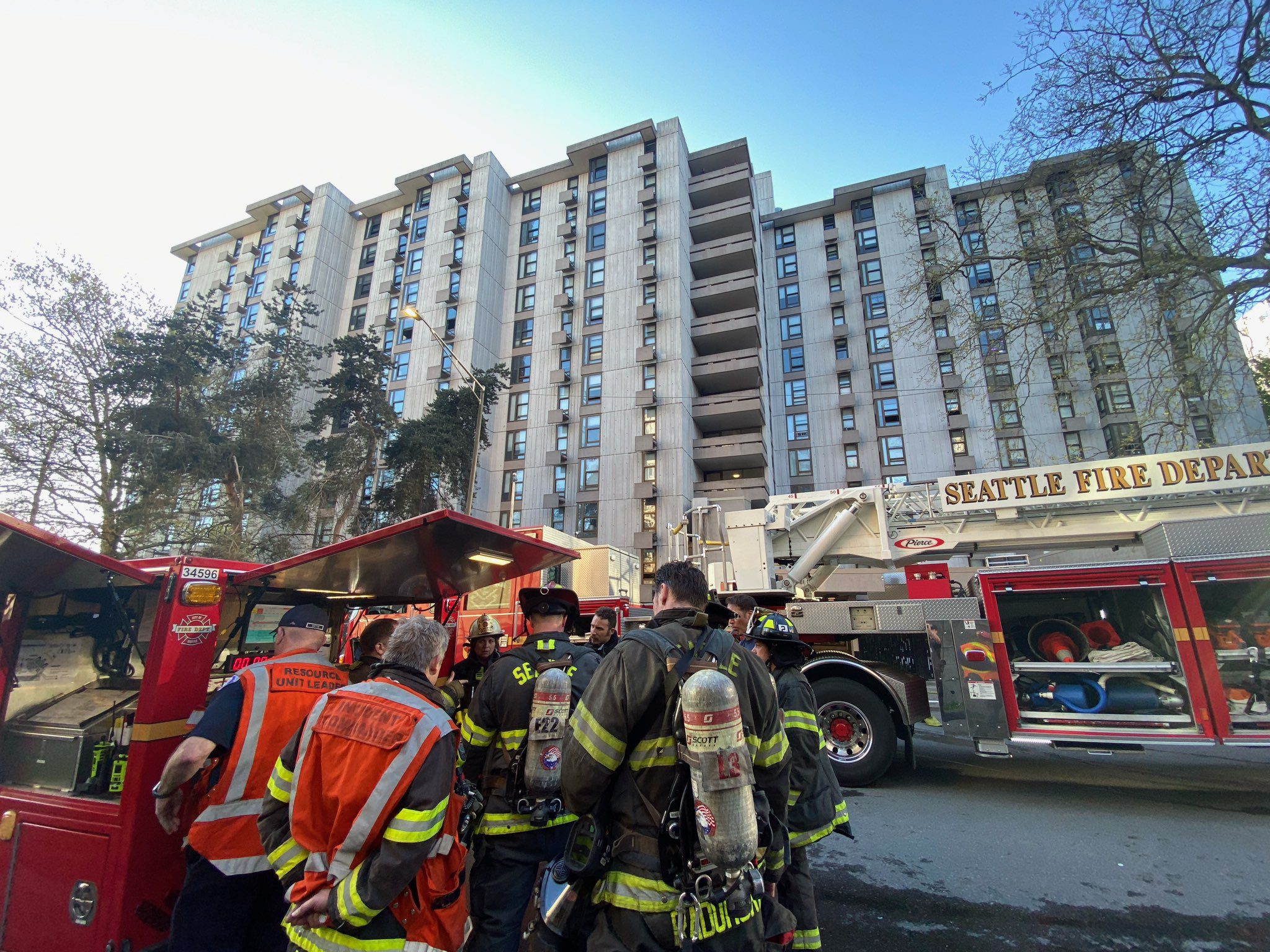 Firefighters gathered outside of fire building.