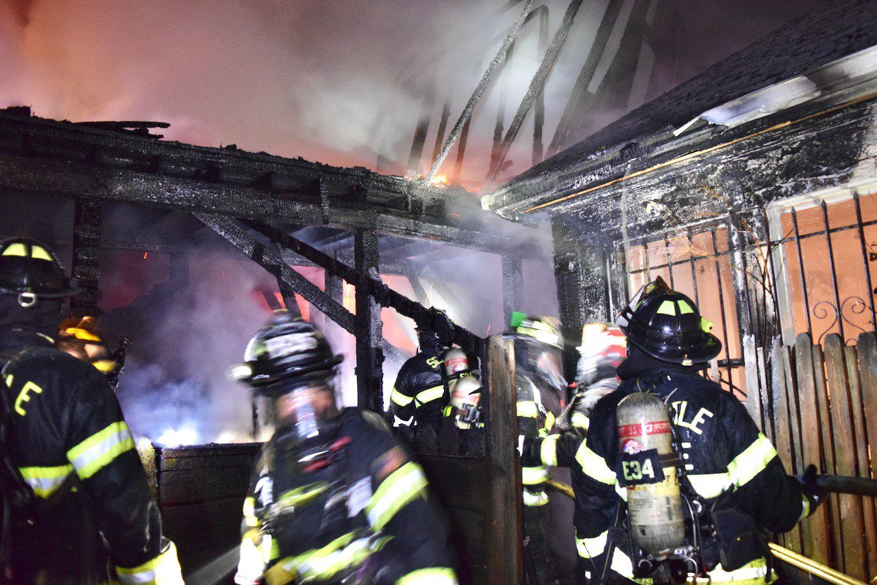 Firefighters work to extinguish a 2-alarm fire