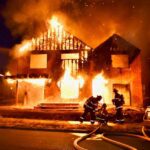 Firefighters put water on a fire involving a residence under construction.