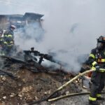 Firefighters extinguish a fire involving a detached garage.