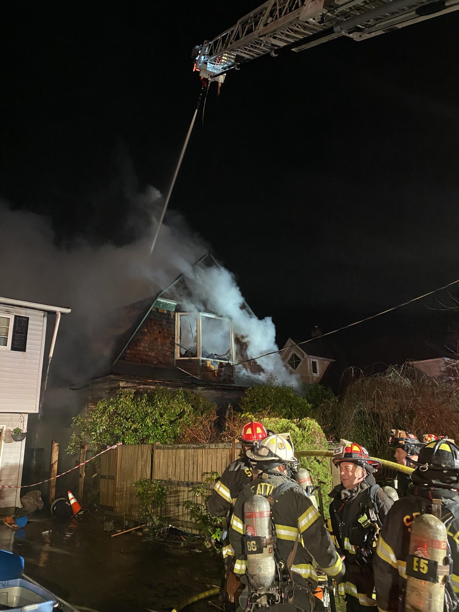 Aerial ladder putting water on the fire.