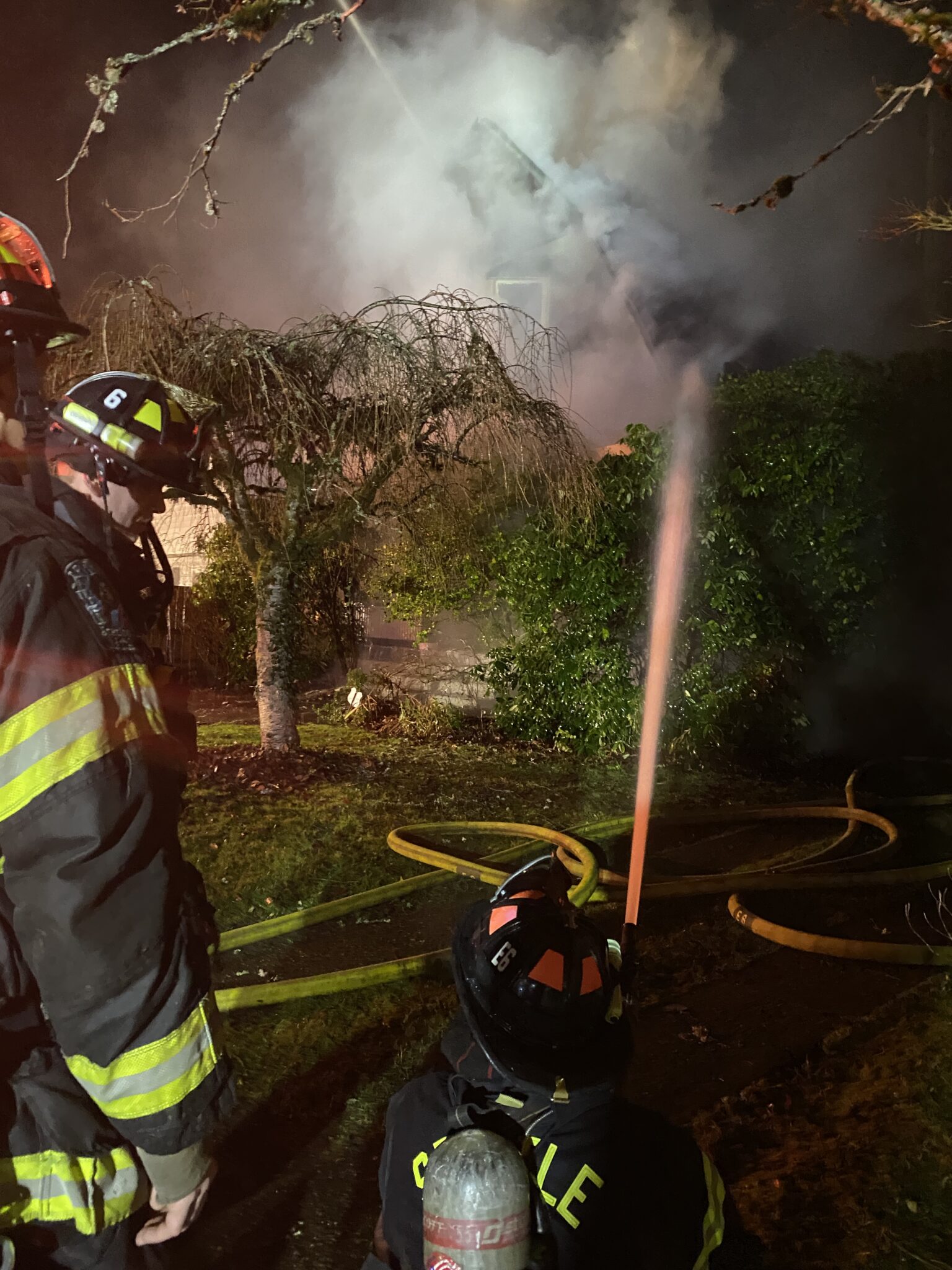 Firefighters putting water on the fire.