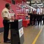 Fire Chief, Harold Scoggins reads the oath to promoting Lieutenants