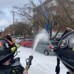 Firefighters put water and foam on the fire