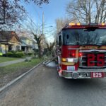 Seattle Fire Engine 25 parked on street by house fire
