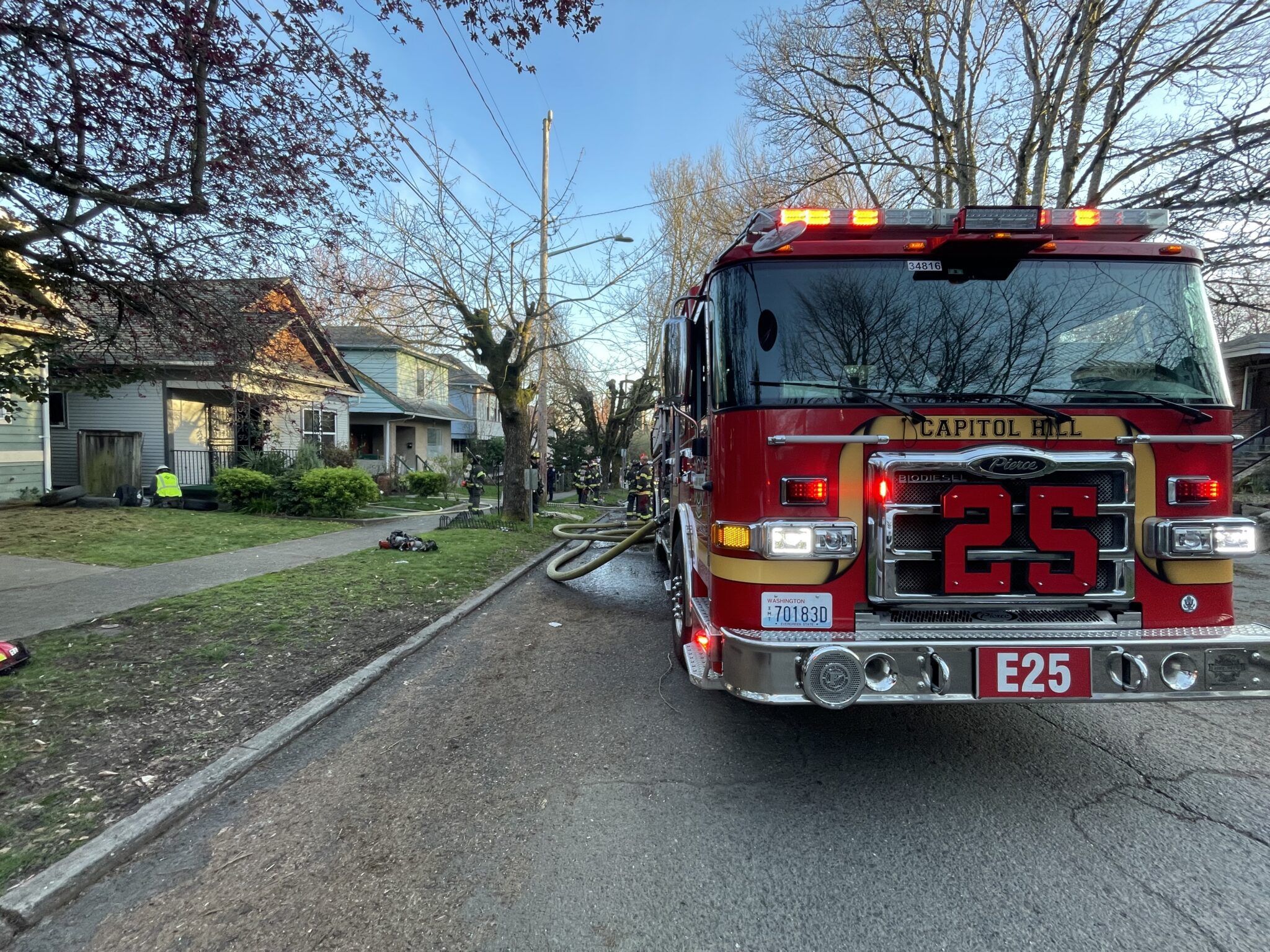 Seattle Fire Engine 25 parked on street by house fire
