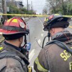 Two firefighters use meter to check for levels or natural gas.