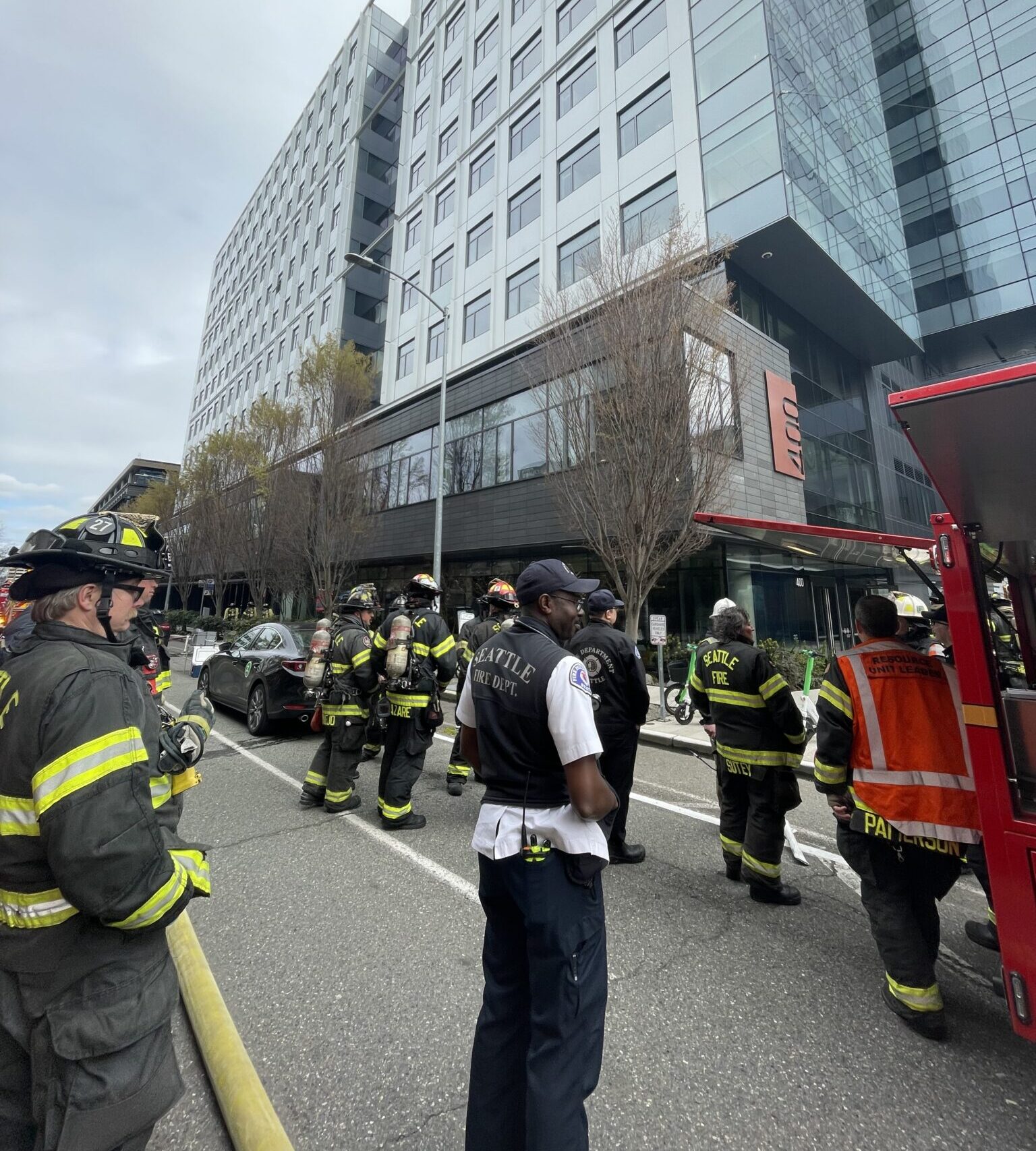Firefighters stand in front of building