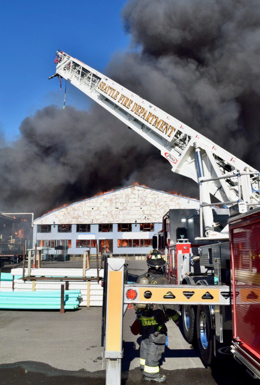 Ladder truck with aerial ladder fully extended.