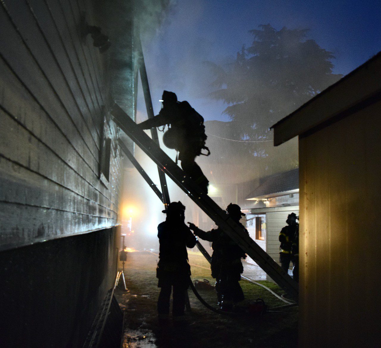 Firefighter climbs ladder