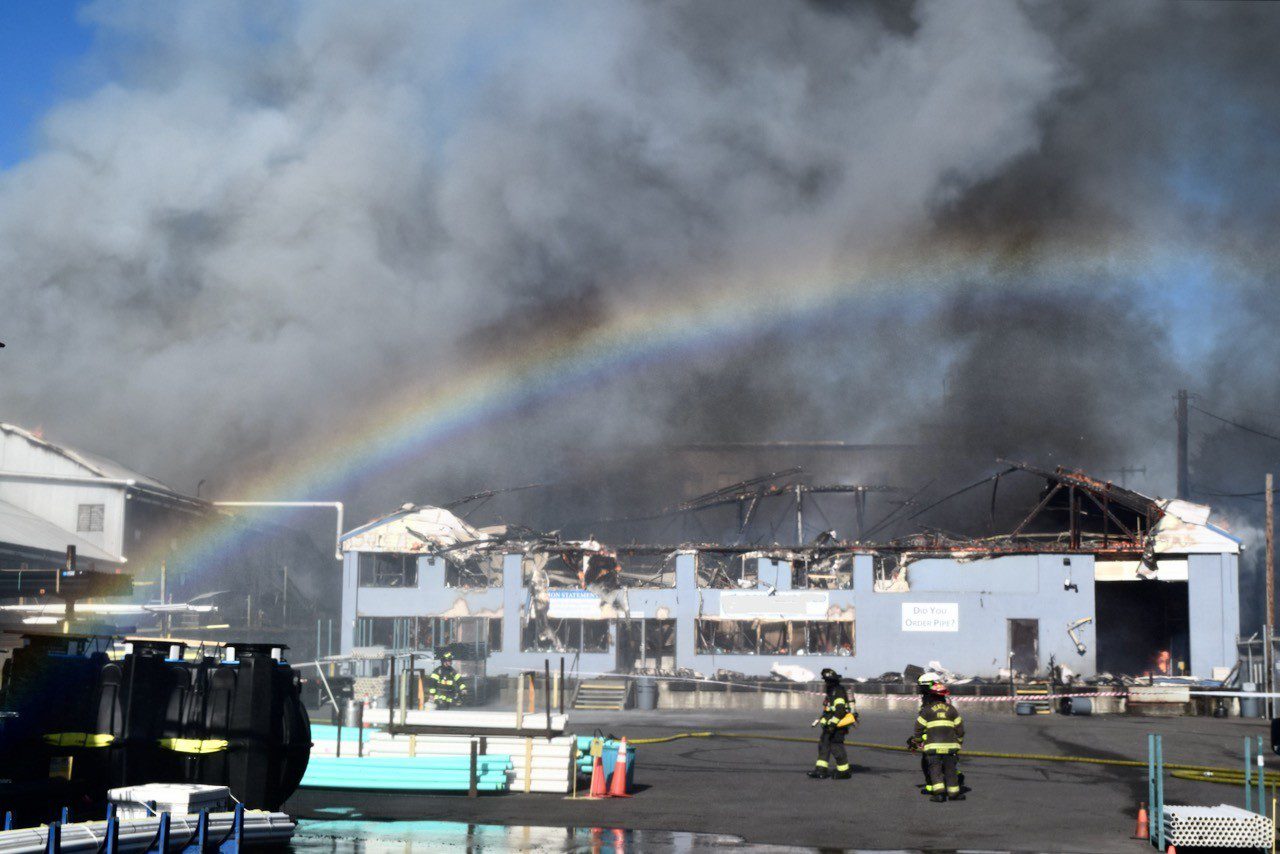 Smoke and flames rise from building.