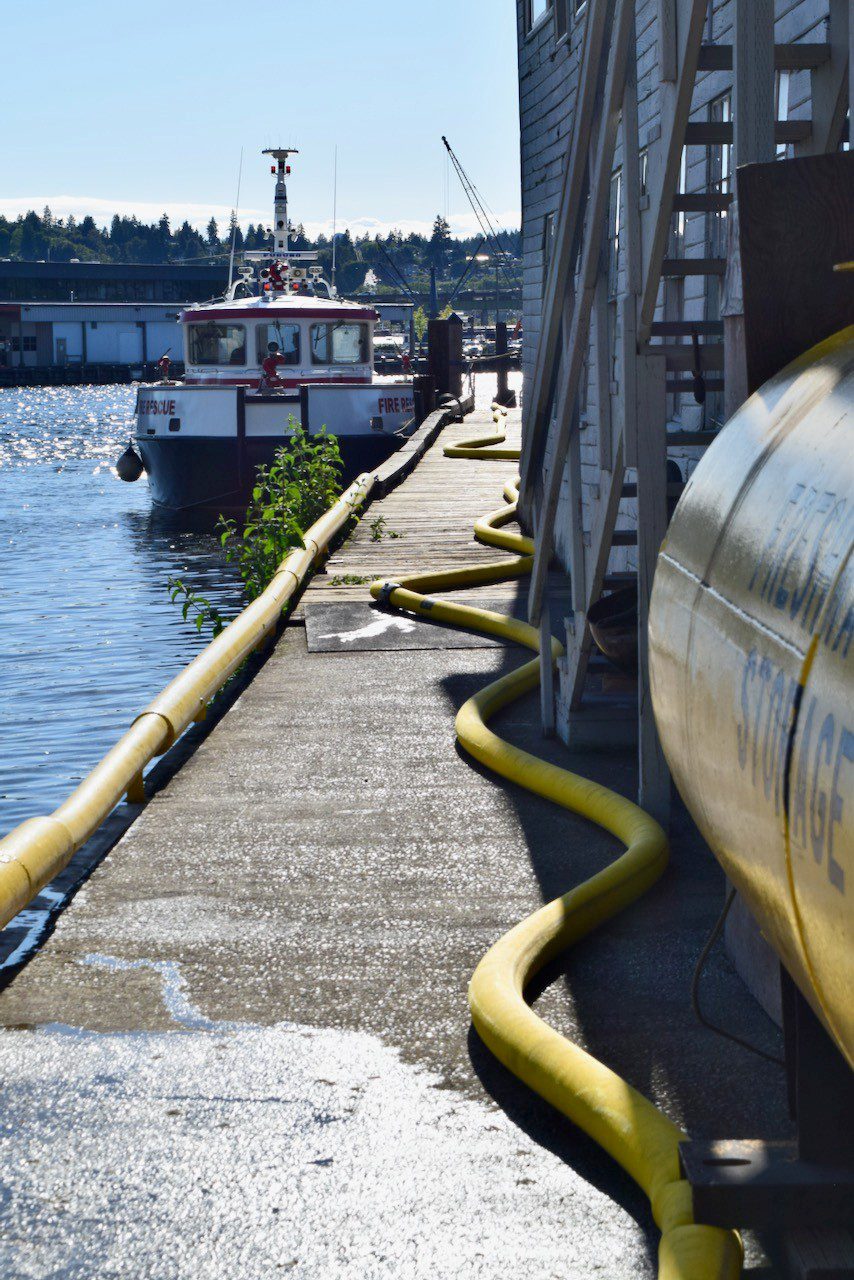 The fireboat in the Ship Canal supplies water through hose lines.