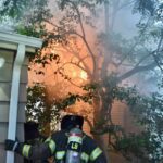 Flames coming from the second floor of a home