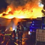 Firefighters put water on a commercial warehouse fire.