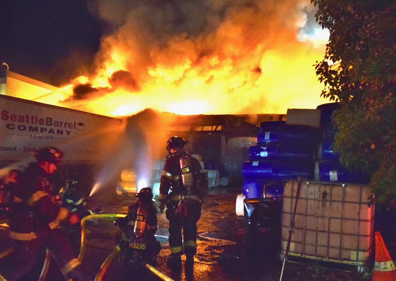 Firefighters put water on a commercial warehouse fire.