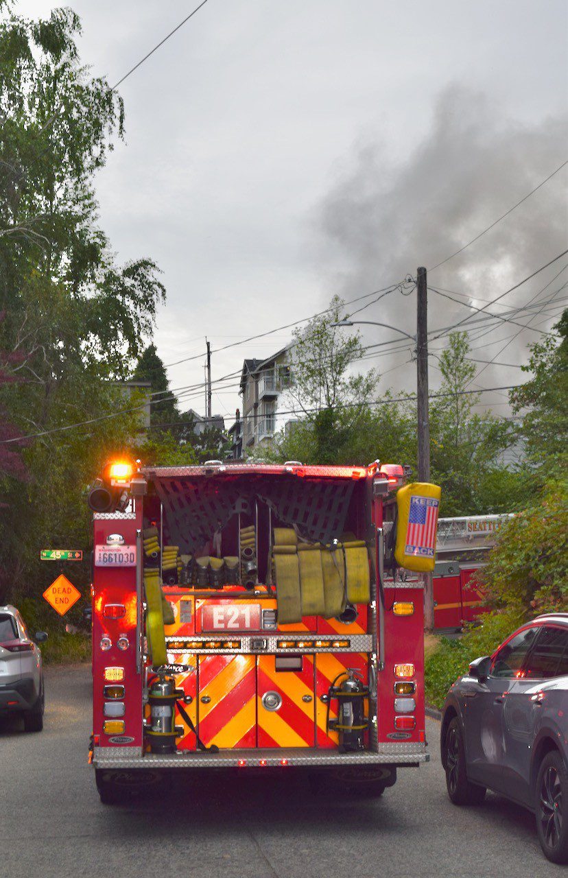 Smoke rising from the fire in distance in front of Engine 21.