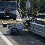 Firefighters work to put out fire in garbage truck