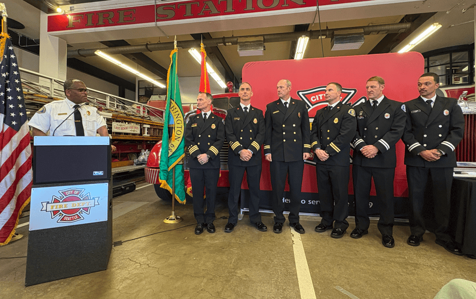 Seattle Fire members being promoted standing together.